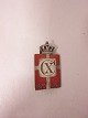 Royal batch made of Sterling silver 925S with red 
enamel motif of the Dannebrog
This batch is made as a brooch
Year 1870-1940 is on as well as Christian X
The Silver smithy of Georg Jensen produced it in 
1940-47