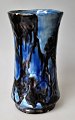 Vase, 8, 
Roskilde 
Lervare 
factory, 
approx. 
1915-1920, 
Denmark. 
Decorated in 
blue and brown 
...