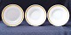 Royal 
Copenhagen 
porcelain. 
Royal 
Copenahgen; 
Gold fan, set 
of three deep 
plates #15151. 
...