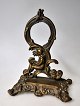 Pocket wach 
holder in 
bronze, 19th 
century. New 
rococo. 
Decorated with 
a girl sitting 
with a ...