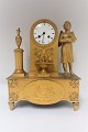French gilded bronze clock. White dial. Height 36 cm. Produced 1810 - 1830