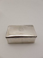 Three-tailed silver cigarette box