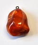 Polished amber 
pendant, 
Denmark. 3.5 x 
2.5 cm.