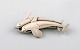 Sterling silver brooch by Georg Jensen. Design number 311. Two dolphins.