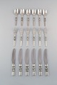 Georg Jensen. Cutlery, Scroll No. 22, Complete dinner service of hammered 
sterling silver.