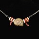 Torben 
Hardenberg. 
Necklace with 
Moon Snail, 
Coral and Puka 
Shell. 
Designed by 
Torben ...