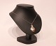 Thin silver 
chain with 
pendant of 
silver with 
karneol.
38 cm and 3 cm 
x 2 cm.