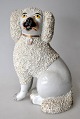Staffordshire 
poodle dog, 
19th century. 
White faience. 
Height: 18 cm.