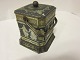 Biscuit-box/Can, made of metal, with a lid and a handle
4-/8-edged can
H: 16,5cm
W: 12cm
Condition good compared with the age