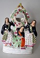 Staffordshire 
figure group 
with watch 
holder, 19th 
century, 
England. 
Polychrome 
decorated. H: 
27 ...