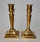 Pair of Danish 
empire 
candlesticks 
brass, 19th 
century. On 
square foot and 
profiled stem. 
...