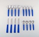 Gense, Sweden. Holiday dinner service, cutlery for four people in stainless 
steel and dark blue melamine plastic. 1960
