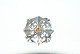 Elegant silver brooch with orange stones