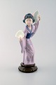 Lladro, Spain. 
Large figure in 
glazed 
porcelain. 
Geisha with 
fans. 20th 
century.
Measures: 29.5 
...