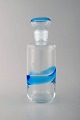 Scandinavian 
glass art. 
Carafe in clear 
and light blue 
art glass. 
1970's.
Measures: 25.5 
x 9.5 ...