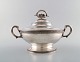 Tiffany & Company (New York). Stylish sterling silver tureen with stylized 
ornament. Curved and oval bowl on raised oval foot. 1870