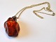 Large polished 
amber jewelery 
with silver 
pendant, 20th 
century 
Denmark. 
Weight: 33.7 
grams. ...