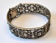 Norwegian arm 
band in silver, 
filigree, 20th 
century. 
Stamped: HO. 
Inner diameter: 
5.8 cm. ...