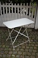 Old French cafe table in white painted steel with fine patina.The table can be folded and is ...