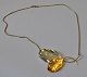 Neck jewelery 
in the form of 
two leaves, 
sterling, 20th 
century 
Denmark. Of 
which a gilded 
one. ...