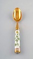 Georg Jensen for Royal Copenhagen. "Flora Danica" dinner spoon of gold plated 
sterling silver. Porcelain handle decorated in colors and gold with flowers.