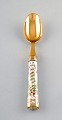 Georg Jensen for Royal Copenhagen. "Flora Danica" dinner spoon of gold plated 
sterling silver. Porcelain handle decorated in colors and gold with flowers.