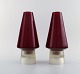 Per Lütken for Holmegaard. A pair of rare "Hygge" lamps for candles in red and 
clear art glass. Designed in 1958.