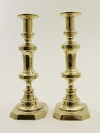 A pair of brass candlesticks with square foot