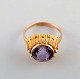 Swedish goldsmith. 18 carat gold ring adorned with purple semi precious stone. 
1970