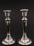 A pair of sterling silver candlesticks sold