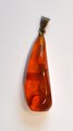 Amber pendant, 
20th century, 
polished. With 
silver pendant. 
L: 4.5 cm.