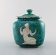 Wilhelm Kåge for Gustavsberg. Large Argenta art deco ceramic lidded jar 
decorated with nude woman in silver inlaid. Sweden 1940
