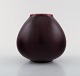 Carl Halier for Royal Copenhagen. Unique ceramic vase in beautiful ox blood 
glaze. Dated 1934.