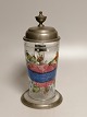 Enamel-
decorated beer 
mug with tin 
lid Germany 
19th century 
Height with 
bark 24.5cm.