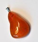 Polished amber piece, Denmark. With silver pendant. L: 4.5 cm.