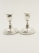 A pair of silver candlesticks sold