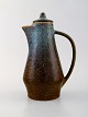 Carl Harry 
Stålhane for 
Rörstrand. Jug 
with lid in 
glazed 
stoneware.
Beautiful 
glaze in blue 
...