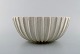 Arne Bang. Stoneware bowl with fluted corpus decorated with sand colored 
eggshell glaze. 1930