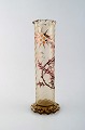 Early Emile Gallé vase in clear frosted art glass. Carved with motifs in the 
form of flowers and leaves. Angular bottom and top. Enamel work and gilt. Ca. 
1885.