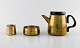 Henning Koppel (1918-81) for Georg Jensen, design 7002.
Coffee pot and sugar / cream set in brass.