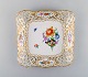Meissen. Square dish in pierced porcelain decorated with flowers and gold 
border.