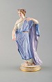 Meissen porcelain figurine. Woman in blue robes with floral wreath in her hair. 
Ca. 1900.