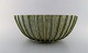 Arne Bang. Colossal stoneware bowl with fluted corpus decorated with green and 
light blue eggshell glaze. 1930