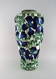 Early colossal 
Alumina vase in 
faience. Blue 
flowers and 
green leaves on 
cream colored 
...