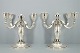 K. C. Hermann; A pair of four armed candlesticks of hallmarked silver, 1930