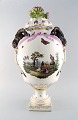 KPM, Berlin. Monumental antique lidded vase in porcelain. Overglaze. Goats and 
pink flowers in relief and hand painted with butterflies and romantic scenery. 
Museum quality. 1860