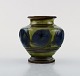 Kähler, HAK, glazed stoneware vase in modern design. 1930 / 40s. Blue leaves on 
green background.
