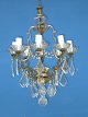 Bronze lamp 
with crystal, 8 
-arms. Width 
46cms. Height 
95cms. Fine 
condition. From 
ca 1920.