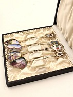 Set of 4 silver spoons with various enamel decorations