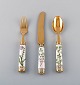 Michelsen for Royal Copenhagen. "Flora Danica" dinner set consisting of dinner 
knife, dinner fork and tableware in gold plated sterling silver. Porcelain 
handles decorated in colors and gold with flowers.
